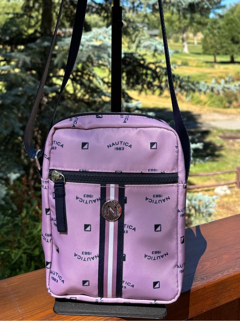 Nautica Pink Logo Print Crossbody Bag with Navy Strap and trim.